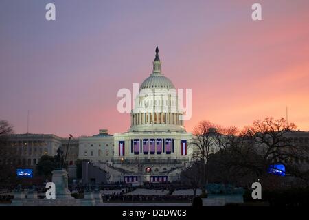 Washington DC. January 21, 2013,  Dawn breaks over the U.S. Capitol Building as inaugural attendees gather in designated areas. President Barack Obama, officially sworn in to a second term yesterday due to a constitutional requirement, takes a ceremonial oath of office today. Stock Photo
