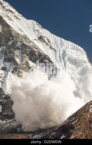 An avalanche on Machapuchare or Fishtail Peak in the Annapurna Himalaya, Nepal. Stock Photo