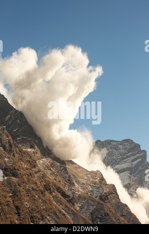 An avalanche on Machapuchare or Fishtail Peak in the Annapurna Himalaya, Nepal. Stock Photo