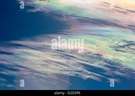 Jet stream winds over the Annapurna Himalayas in Nepal, with rainbow colours caused by refraction on ice crystals in the clouds, known as parhelion or sundog. Stock Photo