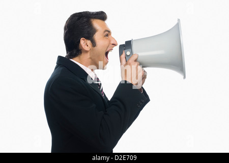 Businessman shouting into a megaphone Stock Photo