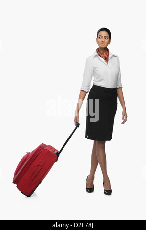 Air hostess carrying her luggage Stock Photo