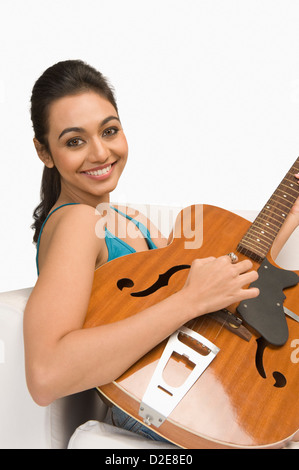 Portrait of very beautiful woman playing guitar Stock Photo - Alamy