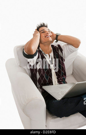 Close-up of a man looking excited while using a laptop Stock Photo