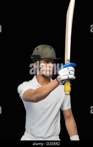 Cricket batsman raising his bat Stock Photo