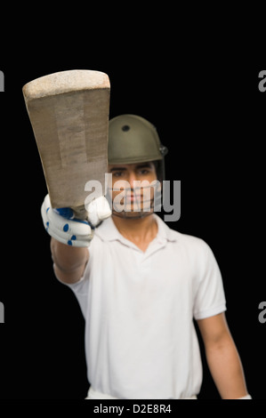 Cricket batsman raising his bat Stock Photo