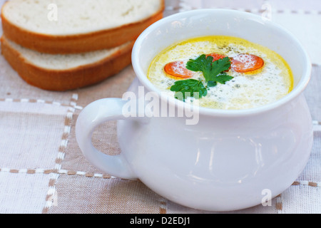 Fish soup close-up, bread in the background Stock Photo