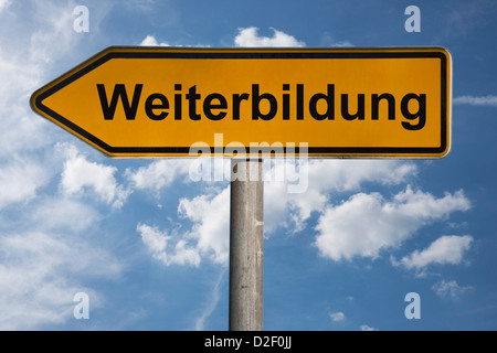 Wegweiser mit der Aufschrift Weiterbildung | Detail photo of a signpost with the German inscription further training Stock Photo