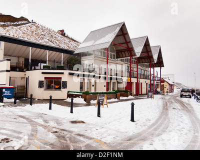 Saltburn sea front shops deserted on a cold snowy day in winter January 2013 Stock Photo