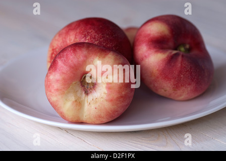 Image of the fruit Flat Nectarines on a plate Stock Photo