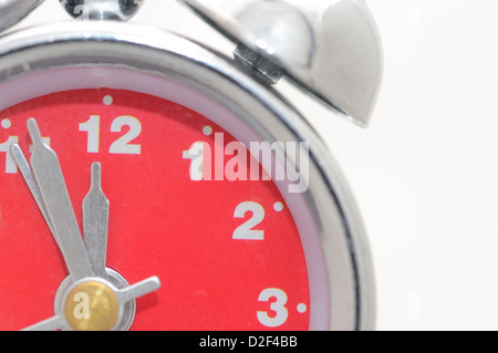 Closeup shot of alarm clock with red dial. Stock Photo