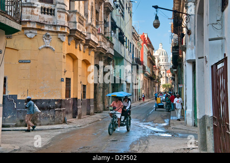 A Bicitaxi or Bicycle Rickshaw Taxi on Calle Brazil, with Capitolio Building behind, Habana Vieja, Havana, Cuba, Caribbean Stock Photo