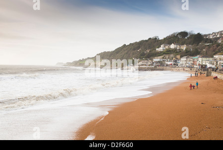 People walk along the golden sands of the beach at Ventnor, Isle of Wight, England. The coastal town is a popular destination. Stock Photo