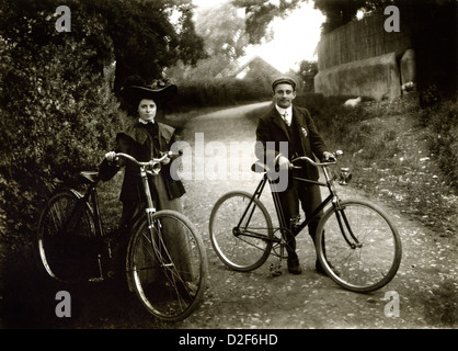 Vintage cycling, man and woman cyclists from turn of century with bikes Stock Photo