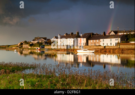 Storm Clouds and Rainbow over Afon Ffraw & Riverside Cottages, Aberffraw, Anglesey, North Wales, UK Stock Photo