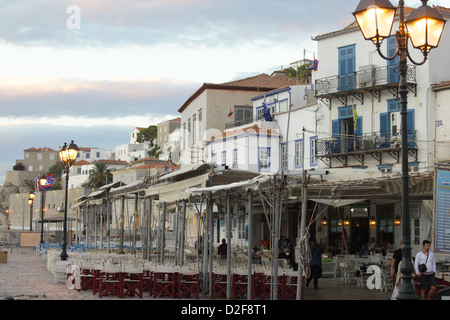 The lamps around Hydra Town's harbour come on as evening falls on the Greek Island, late in the 2012 season. Stock Photo