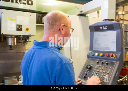 setting up CNC controller for vertical milling machine Stock Photo