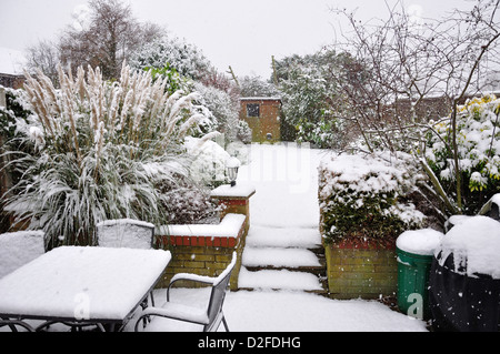 Small garden covered in snow, Stanwell Moor, Surrey, England, United Kingdom Stock Photo