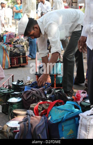 Dabbawalas pack food together for delivery at Andheri Station in Mumbai, India, 20 November 2012. 5,000 food delivers take 175,000 lunches to workplaces every day in Mumbai. Photo: Doreen Fiedler Stock Photo