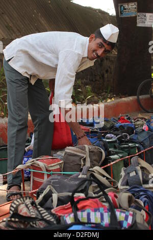 Dabbawalas pack food together for delivery at Andheri Station in Mumbai, India, 20 November 2012. 5,000 food delivers take 175,000 lunches to workplaces every day in Mumbai. Photo: Doreen Fiedler Stock Photo
