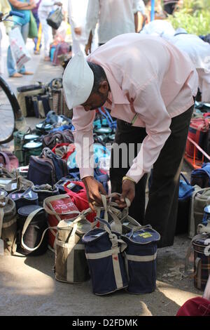 Dabbawalas pack food together for delivery at Andheri Station in Mumbai, India, 20 November 2012. 5,000 food delivers take 175,000 lunches to workplaces every day in Mumbai. Photo: Doreen Fiedler Stock Photo