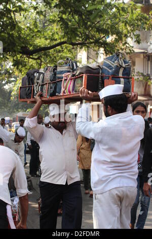 Dabbawalas pack food together for delivery at Andheri Station in Mumbai, India, 20 November 2012. 5,000 food delivers take 175,000 lunches to workplaces every day in Mumbai. Photo: Doreen Fiedler Stock Photo