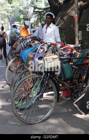 Dabbawalas pack food together for delivery at Andheri Station in Mumbai, India, 20 November 2012. 5,000 food delivers take 175,000 lunches to workplaces every day in Mumbai. Photo: Doreen Fiedler Stock Photo