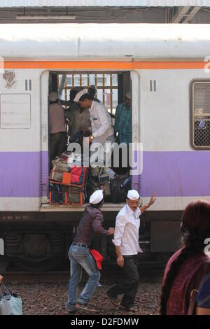 Dabbawalas pack food together for delivery at Andheri Station in Mumbai, India, 20 November 2012. 5,000 food delivers take 175,000 lunches to workplaces every day in Mumbai. Photo: Doreen Fiedler Stock Photo