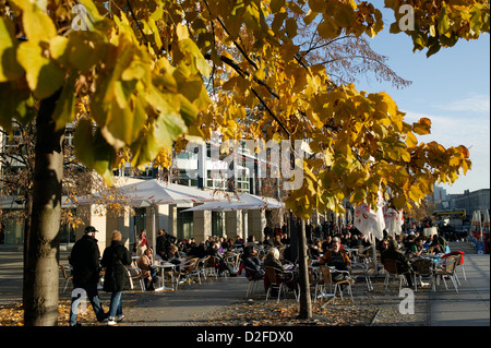 Berlin, Germany, tourists sit in the fall in the street cafes on Spreeufe Stock Photo