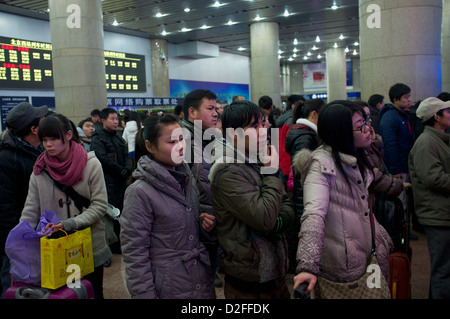 People queue to buy train tickets at a Railway Station in Beijing, China. 22-Jan-2013 Stock Photo