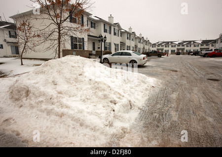 large piles of snow piled up for removal from residential area Saskatoon Saskatchewan Canada Stock Photo