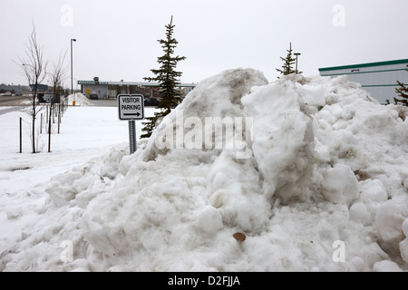 large pile of snow for collection cleared from residential streets Saskatoon Saskatchewan Canada Stock Photo