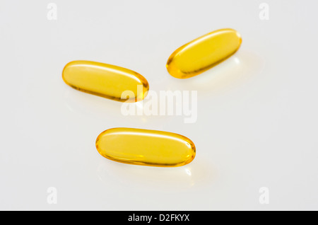 Fish Oil Capsules on an off-white reflective background Stock Photo