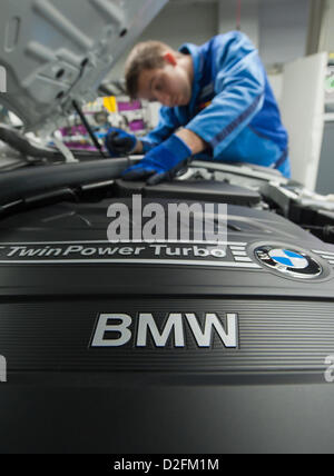 An employee is working on the engine of the new BMW 3 series on Wednesday, 7 March 2012, at the BMW factory in Regensburg. In 2011, BMW made a sales record. It was be best year in the history of the company. Stock Photo