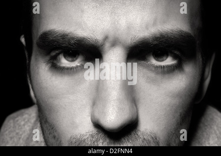 Man's angry eyes close up on white Stock Photo - Alamy