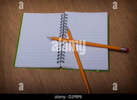 open notebook on a wooden desk with pencil Stock Photo