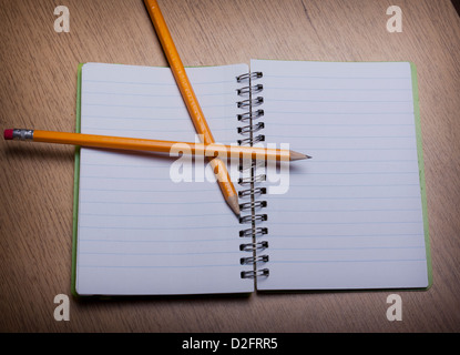 open notebook on a wooden desk with pencil Stock Photo
