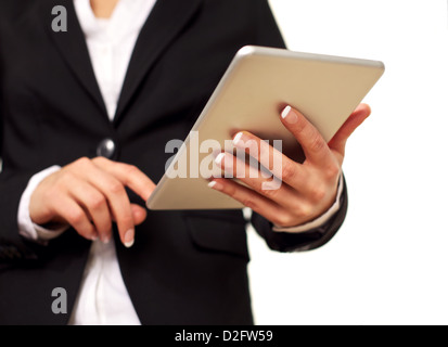 Female keeping her self up-to-date by checking her digital tablet touchpad. Isolated on white background. Stock Photo