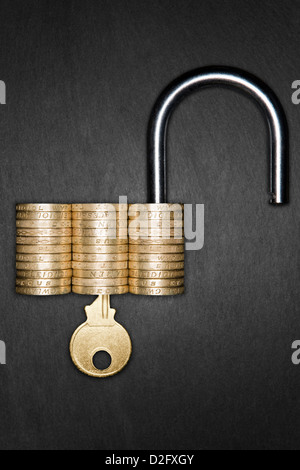 Financial security / savings / ISA concept - Unlocked Padlock made form pound coins with a gold key inserted Stock Photo