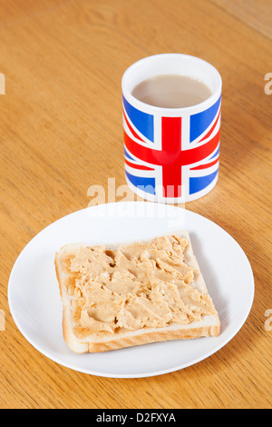 British coffee mug and slice of bread with butter on table Stock Photo