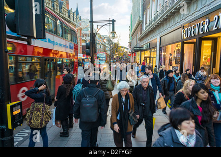 Shoppers in a busy London street - Oxford Street, London, England, UK Stock Photo