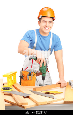 Male worker with a hand drilling machine in a workshop isolated on white background Stock Photo