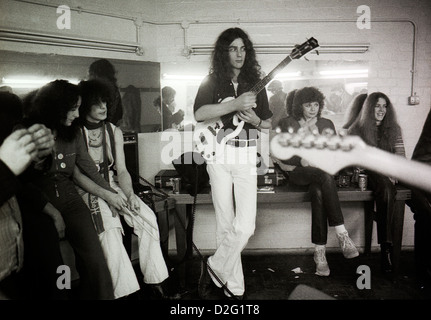 Bass guitarist Duncan Sanderson and drummer Russell Hunter of the 1960s Pink Fairies band and friends backstage before a gig London 1975  KATHY DEWITT Stock Photo