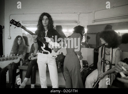 Pink Fairies Duncan Sandy Sanderson standing with guitar and drummer Russell Hunter and friends backstage at Dingwalls Camden in London England UK 1975 Stock Photo