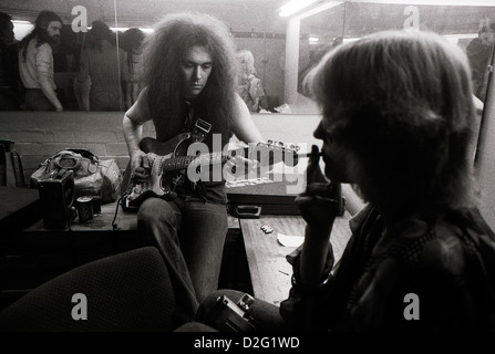 Guitarist Larry Wallis backstage tuning his guitar before gig in Camden London England UK  1974 1975  KATHY DEWITT Stock Photo