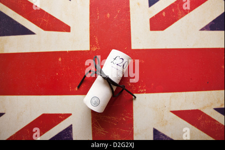Twenty pounds sterling banknote roll on image of Union Jack Flag. Stock Photo