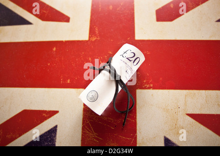 Twenty pounds sterling banknote roll on image of Union Jack Flag. Stock Photo
