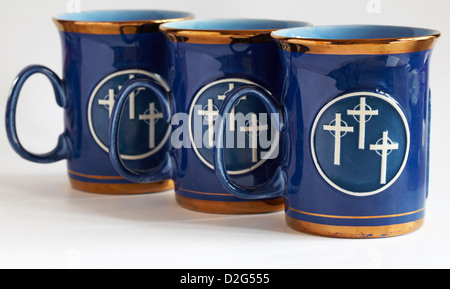 three Trinity Methodist Church blue gold rimmed mugs showing three crosses isolated on white background Stock Photo