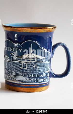 blue gold rimmed mug of Trinity Methodist Church isolated on white background Stock Photo