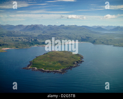 The anthrax Island, Gruinard Island and Bay from the air, North West Scotland, UK, the wilderness mountains of Wester Ross behind Stock Photo